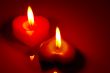 Two burning heart shaped candles