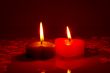 Two burning heart shaped candles
