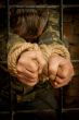 Man with hands tied with rope