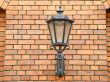 The lantern on the wall of bricks