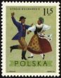 Polish folk dancers from Rozbarskie region on post stamp