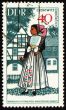 Young woman in national costume on post stamp