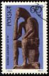 Statue of seated man on post stamp