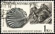 Mountains and mollusc fossil on post stamp