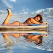 sexy woman with an air mattress in the water