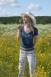 Beautiful girl in field with yellow flower