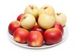 Red and yellow apple on plate