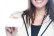 Young business woman with a business card