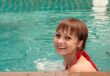 Beautiful girl in pool smiles
