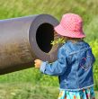 Little girl, gun and yellow flowers