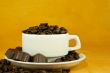 Cup full with coffee beans and chocolate candies
