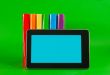 Row of colorful books and tablet PC