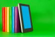 Row of colorful books and tablet PC
