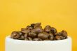 Cup full with coffee beans