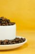 Cup full with coffee beans