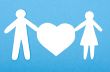 Closeup of paper people with a big heart on white background