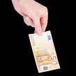 Money (Euro) in a hand isolated on black