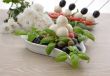 Appetizer of mozzarella, cherry tomatoes and olives and basil
