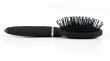 Black hairbrush massage on a light background
