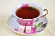 A cup of tea and sugar in isolation on a white background