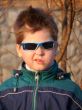 A boy with glasses with a grimace on his face