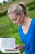 A girl student with a book in the park