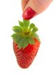 Large strawberries in a female hand isolated on white background 