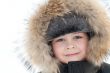 Portrait of a boy in a jacket with fur