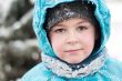 Portrait of a boy with wet snow from the face of