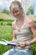 A girl student with a book in the park