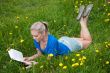 A girl student with a book in the park