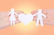 Paper family in hand with a big hearth isolated on white