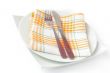 Napkin, folded on a plate with knife and fork 