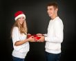 The man gives the gift pregnant girl in Santa hat