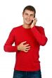 man in a red dress speaks on a mobile phone.