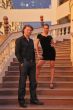couple is posing on the stairs and