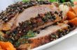 A piece of pork hams at different peppers and carrots and onions