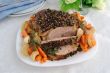 A piece of pork hams at different peppers and carrots and onions