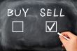 Buy or sell check boxes written on a blackboard