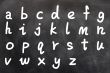 English alphabet handwritten with white chalk on a blackboard