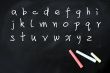 English alphabet handwritten with white chalk on a blackboard