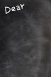 Title of Dear written with chalk on a blackboard 