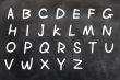 English alphabet handwritten with white chalk on a blackboard