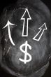 US Dollar symbol with up arrows on blackboard