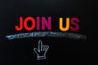Join us - text on a blackboard