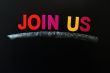 Join us - text on a blackboard