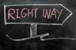 Signpost of right way drawn in chalk on a blackboard