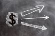 US Dollar symbol with up arrows written on blackboard