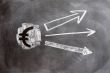 Euro symbol with up arrows written on blackboard