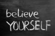 Believe yourself text written on blackboard